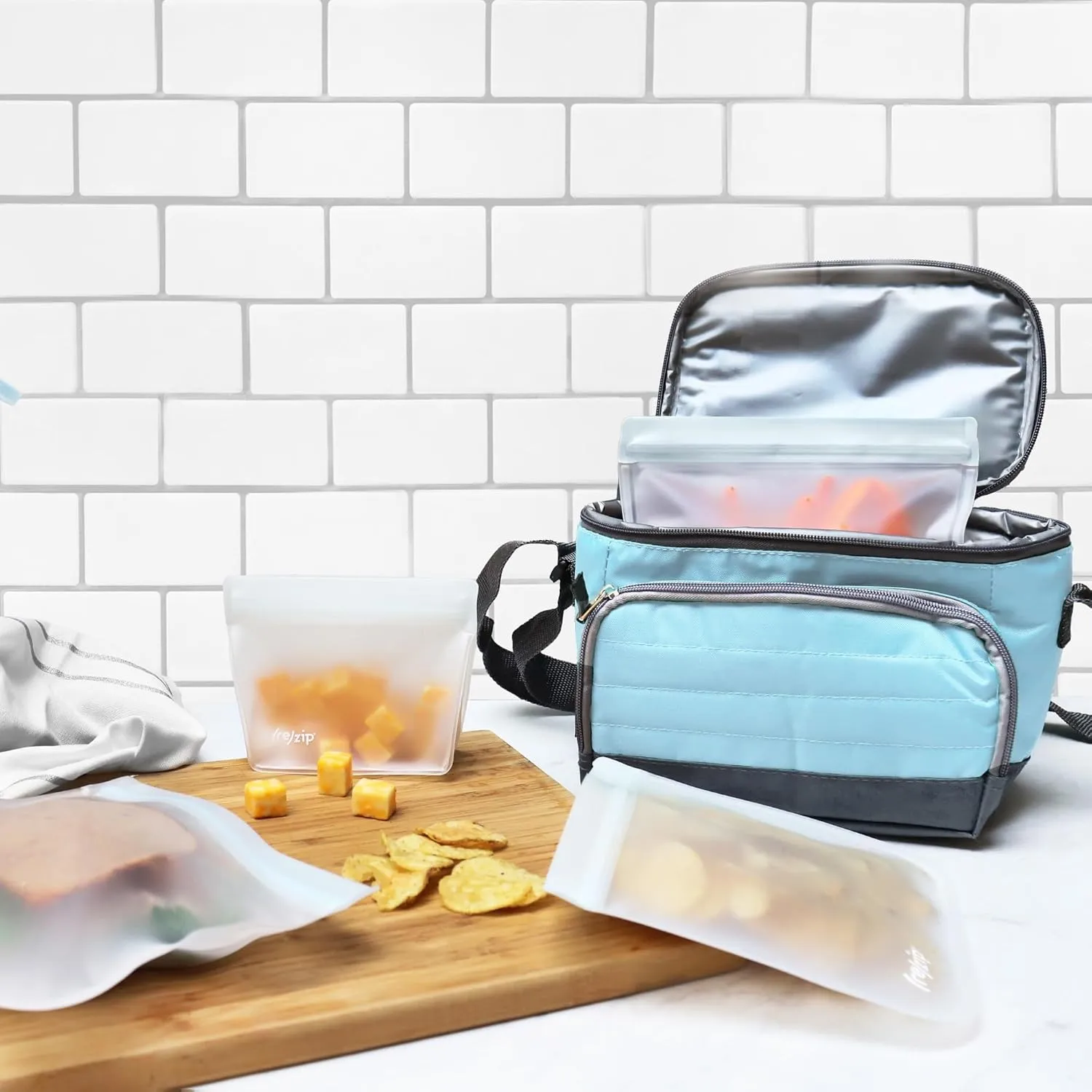 (re)zip 4-Piece Reusable Essential Bags Kit | BPA-Free, Leakproof, Food-Grade 100% Food-Safe PEVA, for Food Storage and Freezer Use, Travel Friendly | Includes 1 Gallon, 2 Lunch/Sandwich, 1 Snack Bags